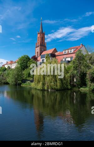 Rathenow, Germany. 05th May, 2020. The protestant town church of St. Marien und Andreas on the banks of the town canal that flows into the Havel. The original construction of the town church dates back to the 13th century and was also made of bricks. At the end of the war in 1945 the church was severely damaged by artillery fire and incendiary grenades and burned out. The tower was restored in 2011, as was the vault in the Chapel of Our Lady and, one year earlier, the vault in the central nave. The restoration is not yet complete. Credit: Soeren Stache/dpa-Zentralbild/ZB/dpa/Alamy Live News Stock Photo