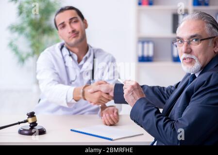 Male doctor in courthouse meeting with the lawyer Stock Photo
