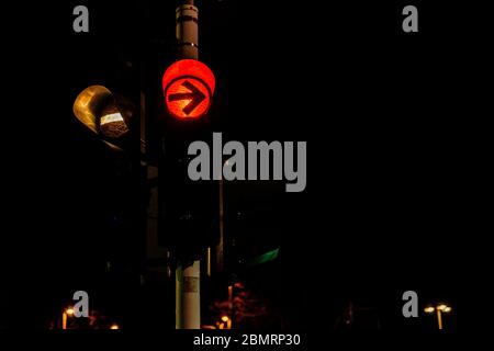 Closeup of colorful traffic lights with arrows in night city 2020 Stock Photo
