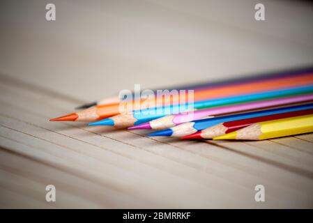 Colourful Pencils Isolated on Wooden Background. Stock Photo