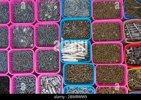 Bolts and screws in box, close up, top view Stock Photo