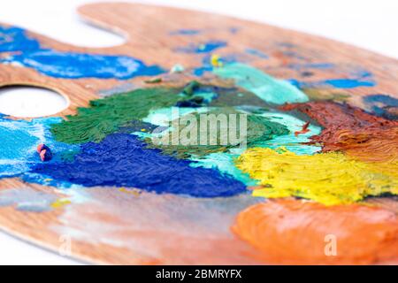 Artist oil paint wooden palette,  with mixed  paint colours mixed.  Art and craft supplies concept Stock Photo