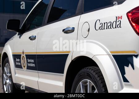 Government of Canada logo in-focus on a Canada Border Services Agency vehicle. Stock Photo