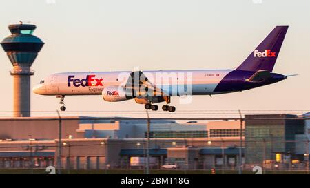 FedEx Express plane, a Boeing 757-F landing at Toronto Pearson Airport late in the day. Stock Photo