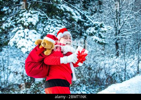 Winter landscape of forest and snow with santa claus. Cold December. Santa Claus comes with gifts from the outside Stock Photo