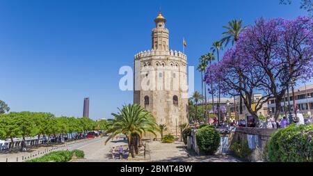 Golden tower at the riverbank park in Sevilla, Spain Stock Photo