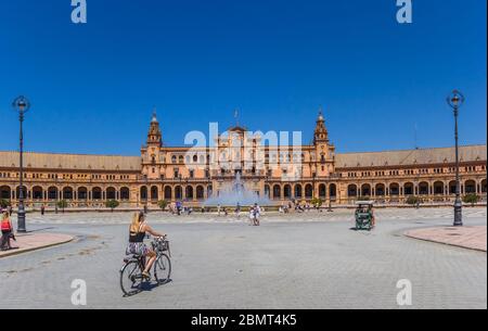 Woman riding a bicycle at the Plaza Espana in Sevilla, Spain Stock Photo