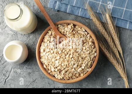 Composition with oatmeal flakes on gray background. Cooking breakfast Stock Photo