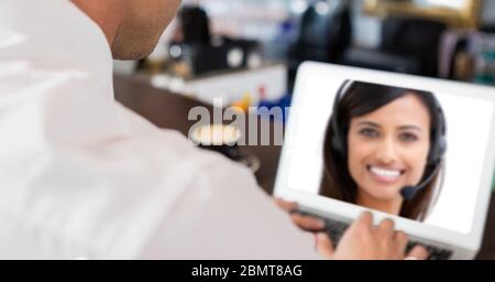 Businessman having video call with a woman on laptop Stock Photo