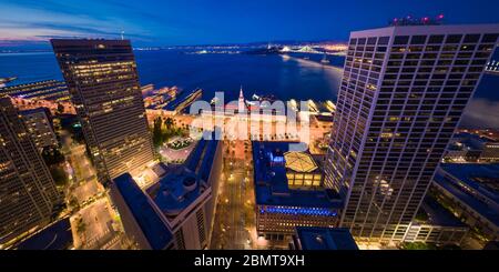 Aerial Panoramic Cityscape View of San Francisco Skyline and Ferry Building at Dusk with City Lights, California, USA - Empty During Shelter in Place Stock Photo
