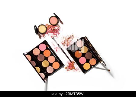 Eye shadow colour pallettes make up kit in a set on white background with harsh hi-key lighting and shadows Stock Photo