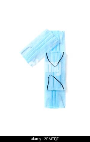 Number one made from protective medical masks on a white background. Stock Photo