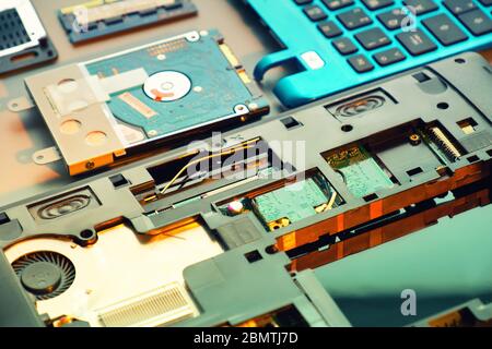Closeup on electronic motherboard card in hardware repair shop. Blurred image with opened laptop circuitry, close-up on electronics. Toned background Stock Photo