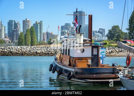 Old wooden boat in Vancouver heritage harbour, Vancouver skylin in the background, British Columbia, Canada Stock Photo