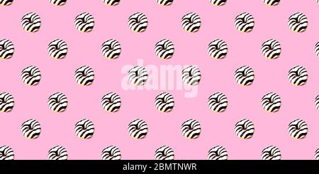 Pattern made of glazed donut on pink background. Party food concept with copy space. Top view. Stock Photo