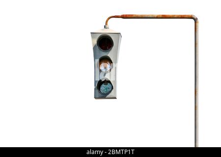 Isolated vintage old traffic light on a rusty post. Close-up. Stock Photo