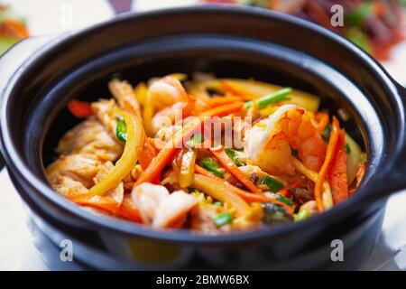 Asian seafood in pot.Delicious jambalaya recipe with boiled shrimips,chicken meat & fresh vegetables.Natural sea food from restraurant with Vietnamese Stock Photo