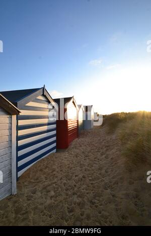 Southwold beach huts shimmering under the sun, Suffolk, United Kingdom Stock Photo