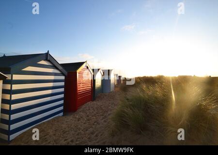 Southwold beach huts, bright sun shining, Suffolk, United Kingdom Stock Photo