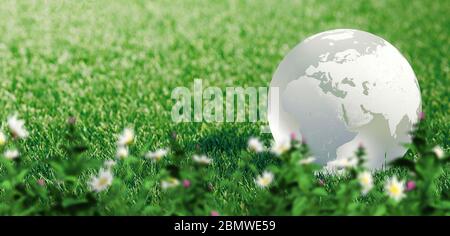 Glass globe or earth in green grass showing eco concept with copyspace ...