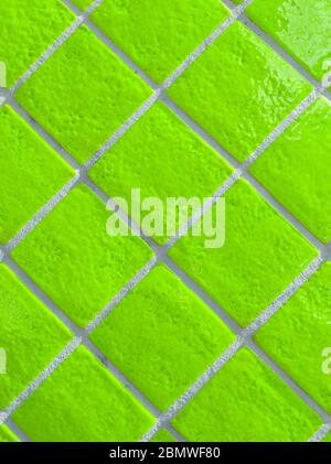 Neon green tiled wall pattern with textured glazed surface Stock Photo