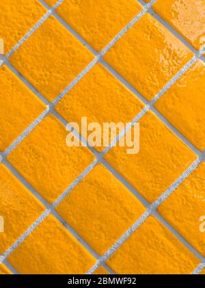 Orange tiled wall pattern with textured glazed surface Stock Photo