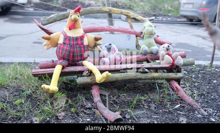 concept spring composition of Lonely forgotten abandonedvintage toys sit on a wooden bench ( depression, loneliness, farewell) background of road Stock Photo