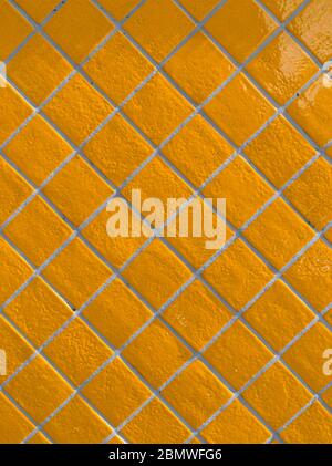Orange tiled wall pattern with textured glazed surface Stock Photo