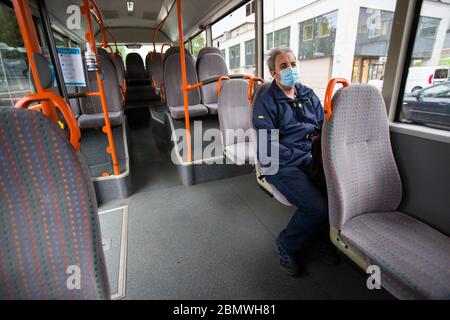A man inside a bus wearing a face mask as a preventive measure as public transport resumes under strick safety measures.Public transport in Slovenia resumed after two months of Coronavirus (COVID-19) lockdown. Stock Photo