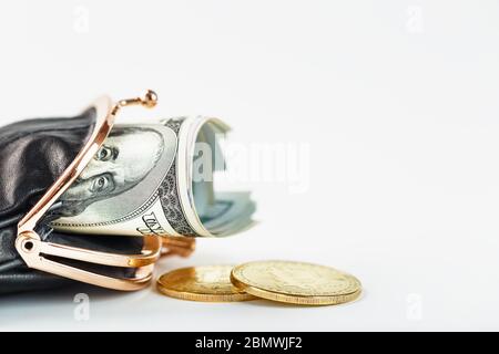 An open black wallet with money, dollars and bitcoin coins on a white background. Isolate, close-up, Studio light. Free space. Stock Photo