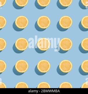 Lemon citrus fruits seamless pattern on blue minimal background, tropical fresh juicy slices Stock Photo