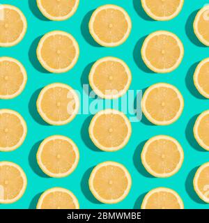 Lemon citrus fruits seamless pattern on green turquoise minimal background, tropical fresh juicy slices Stock Photo