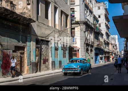 Vintage car driving down famous Neptuno Street, Havana Centro district, Havana, Cuba Stock Photo