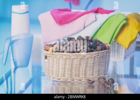 Basket full of soap nuts, natural bio detergent and laundry Stock Photo