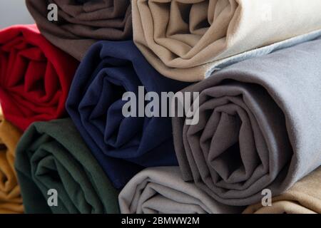 Many different colorful rolls of fabric Stock Photo