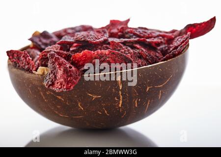 Diet healthy eating concept. Dried beet chips or baked beets in a bowl isolated on a white background. Organic natural food. Copy space. Stock Photo