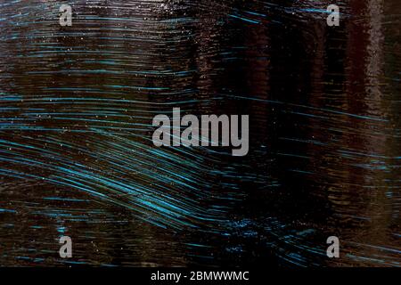 The texture of the painted metal is blue and black. Blue and black Stock Photo