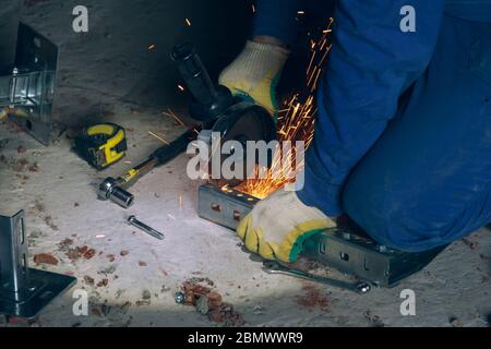 Builder worker with cut-off machine power tool breaking asphalt at road ...