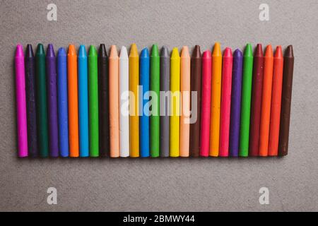 Crayons background, Colored Pencils on grey paper Stock Photo