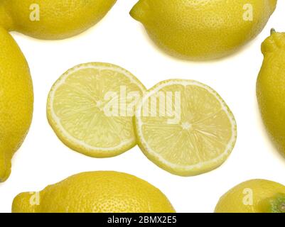 Yellow lemons and two their slices isolated on white background Stock Photo