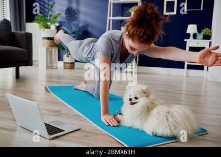 Woman doing some yoga exercises at home Stock Photo