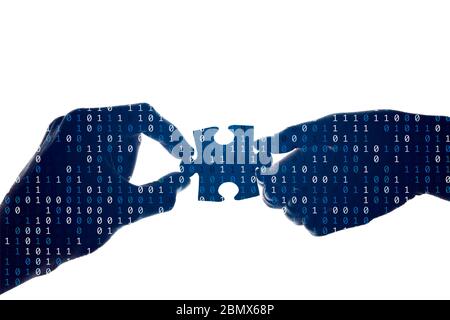 Silhouette of a hands holding a jigsaw puzzle piece with binary background Stock Photo