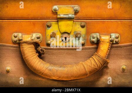 Close up of a vintage weathered brown leather suitcase with lock and handle Stock Photo