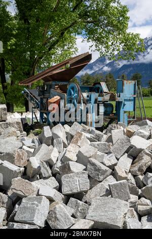 cut stones and blocks with an old rock cutting machine in the background Stock Photo
