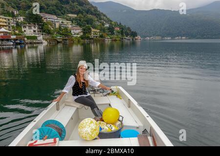 Lugano, Switzerland - 18 Oktober 2016: woman in her fishing boat on lake Lugano on Switzerland Stock Photo