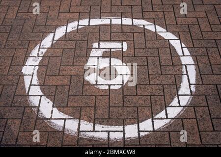 5 mph sign in a circle painted on a block road Stock Photo