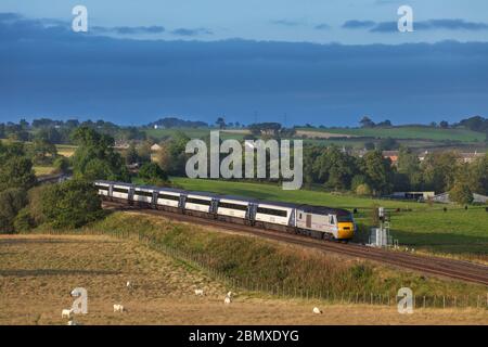 East Coast high speed train ( Intercity 125 ) passing low row on the Tyne valley line with a diverted east coast mainline express train, 43311 leading Stock Photo