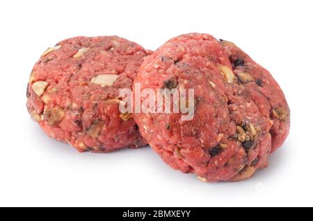 Studio shot of uncooked beef burger cut out against a white background - John Gollop Stock Photo