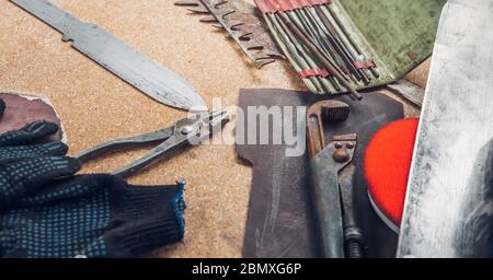 Working tools on wooden rustic background. top view. Knife making concept Stock Photo