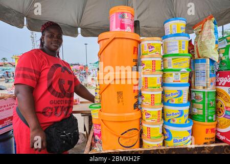 A grocery seller pose for a photo at a makeshift market where she sells provisions in Lagos, Nigeria. Stock Photo